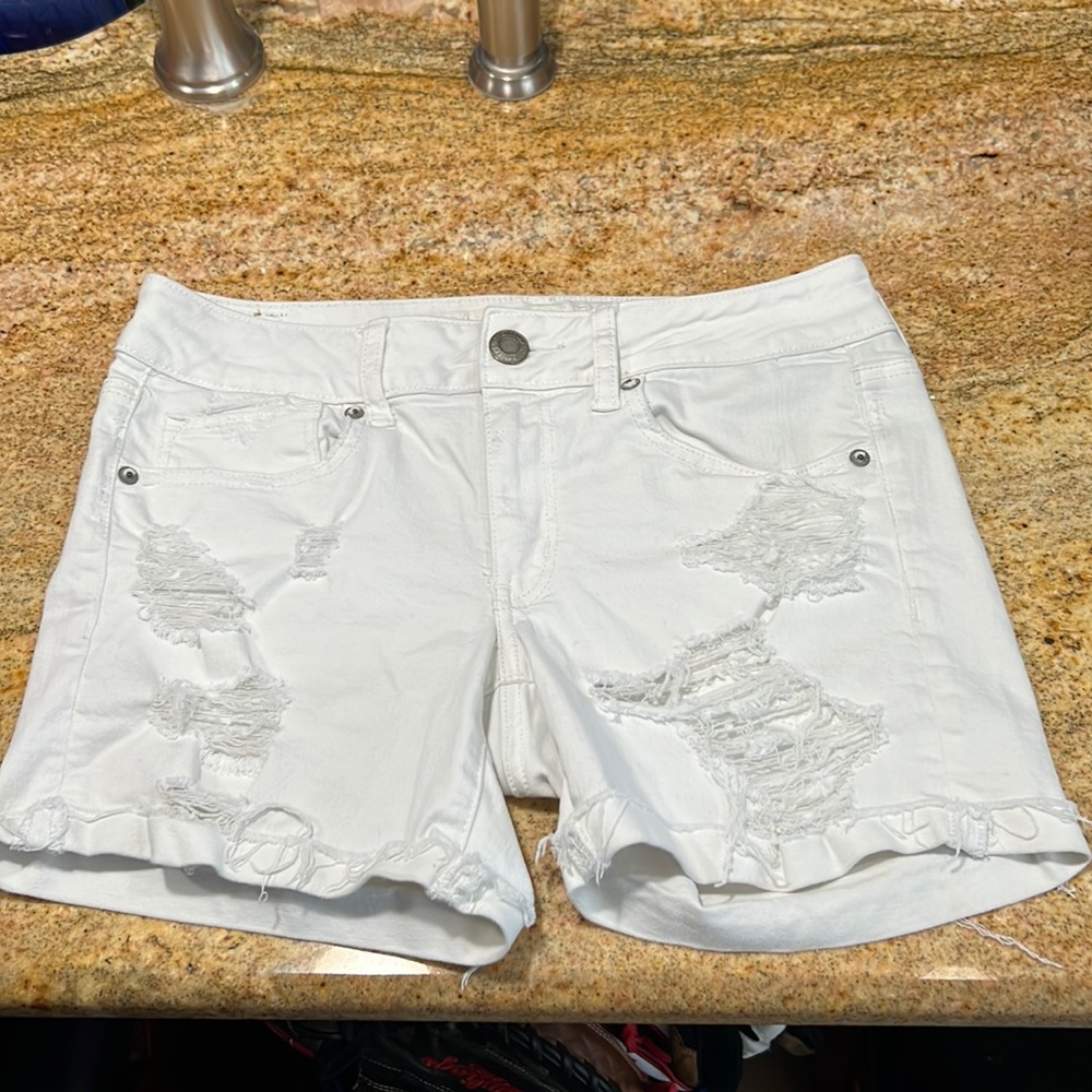 White jean midi American Eagle shorts with holes. Great condition